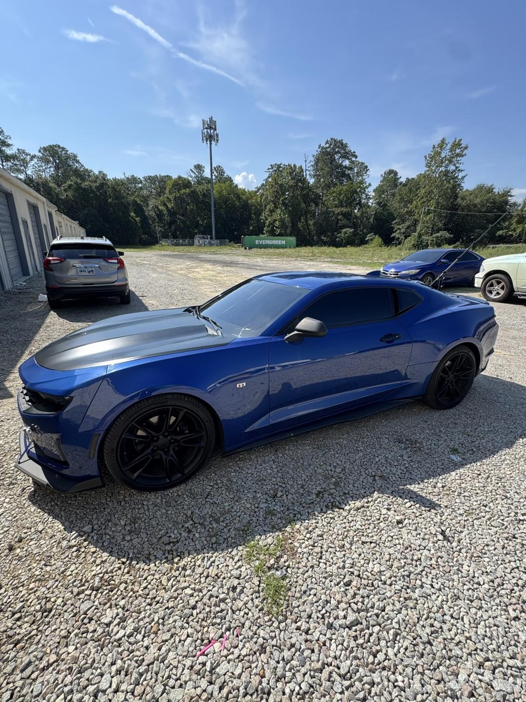Blue Chevrolet Camaro with tinted windows, side view