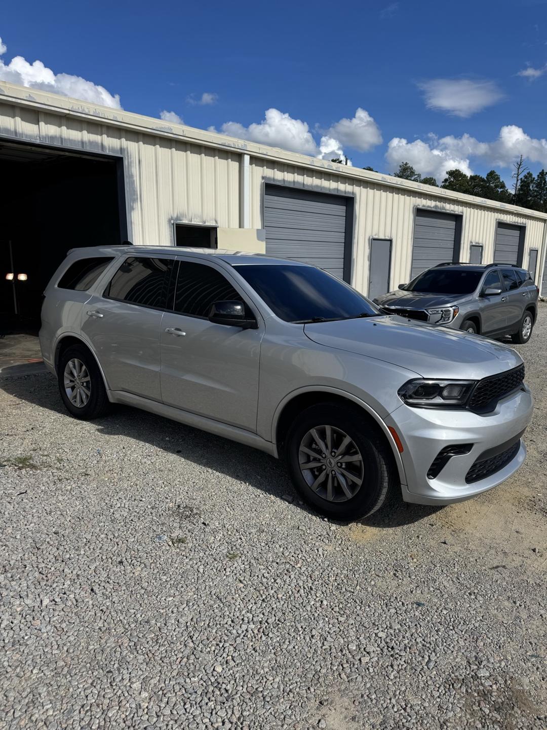 Silver Dodge Durango with tinted windows, side view
